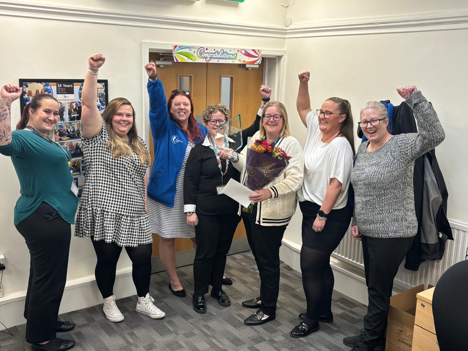 Kellie and team congratulating her 